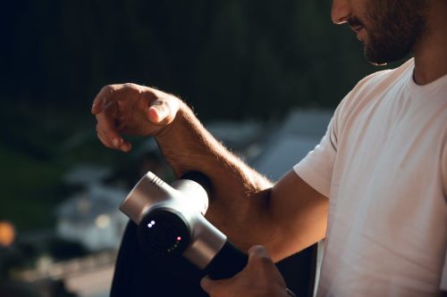 massage gun on forearm