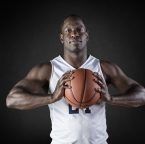 African,American,Basketball,Player,Portrait,Holding,A,Ball.,Black,Background